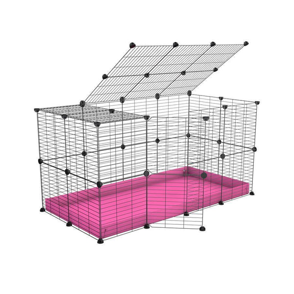 Une cavy cage modulaire 4x2 pour lapins avec un couvercle un coroplast rose et des grilles a barreaux etroits par kavee